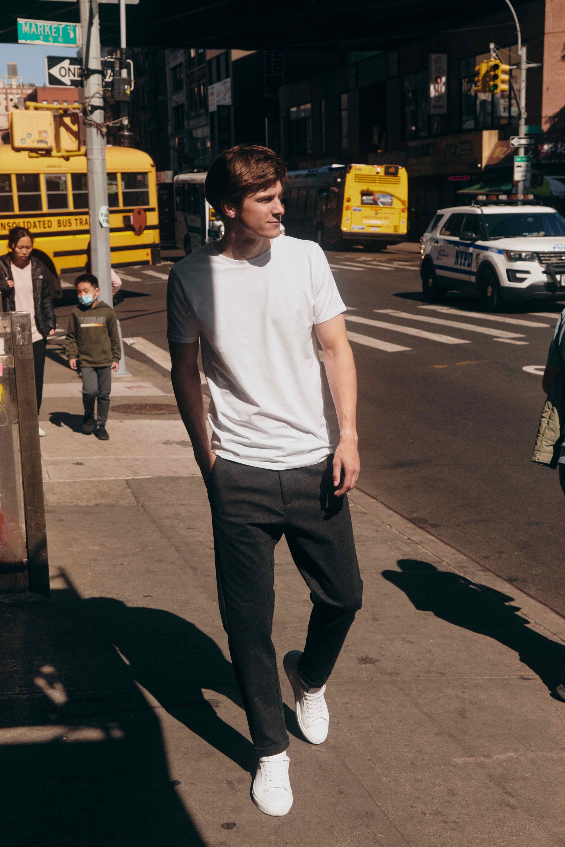 man in white T-shirt from Lindbergh walking on a street
