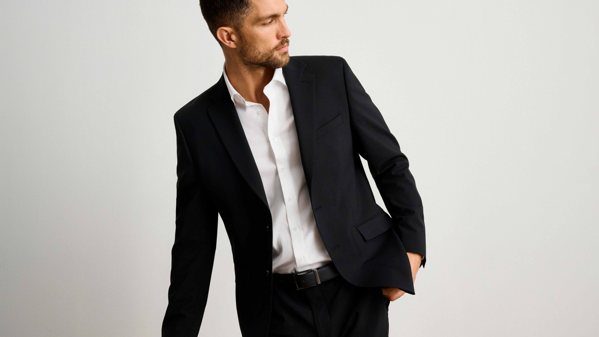 Model in a black Lindbergh suit and a white Lindbergh shirt
